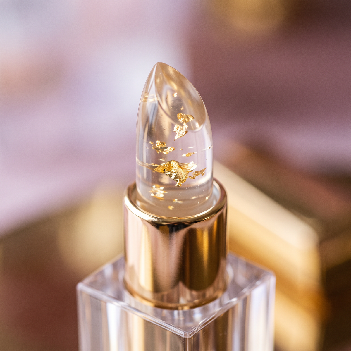 Macro of the clear bullet tip showing suspended gold leaf flakes